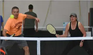  ?? BARRY TAGLIEBER — FOR MEDIANEWS GROUP ?? Partners Larry Killcullen and Joyce Clark watch the return during the Pickleball Tournament.