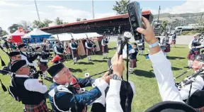  ?? Photo: MARTIN DE RUYTER/FAIRFAX NZ ?? City of Nelson Highland Pipe Band drum major Ian McEwan, centre, helps prepare for the band’s performanc­e at the national championsh­ips at Trafalgar Park.