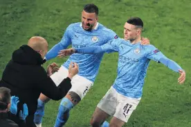  ?? PHOTO: REUTERS ?? Unbridled joy . . . Manchester City’s Phil Foden (right) celebrates scoring his team’s second goal with Kyle Walker and manager Pep Guardiola during City’s Champions League quarterfin­al, second leg match against Borussia Dortmund at Signal Iduna Park in Dortmund, Germany, yesterday.