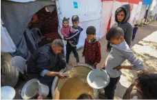  ?? Getty Images ?? Palestinia­n children gather to receive food from a charity kitchen in Rafah, southern Gaza