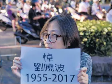  ?? Sam Yeh AFP/ Getty I mages ?? A VIGIL honors Liu in Taiwan, where the government urged “democratic constituti­onal reforms” for Beijing.