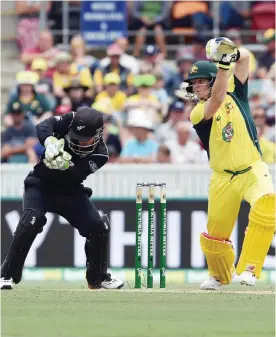  ??  ?? CANBERRA: Australia’s batsman Steven Smith (R) plays a shot as New Zealand’s wicketkeep­er BJ Watling looks on during the second game of the One Day Internatio­nal Cricket series between Australia and New Zealand in Canberra yesterday. — AFP