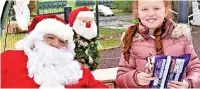  ?? ?? ●●Molly Thompson enjoyed chatting to Santa before receiving her gift