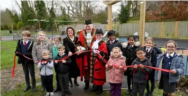  ?? ?? OPEN FOR FUN: Wokingham town mayor, Cllr Tony Lack, with mini mayor Joseph and children from Wokingham schools. Picture: Wokingham Town Council