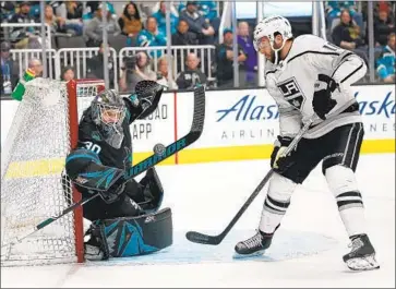  ?? Tony Avelar Associated Press ?? MICHAEL AMADIO of the Kings (10) has his shot blocked by San Jose goaltender Aaron Dell, who made 35 saves but couldn’t reach a loose puck and was beaten by Jeff Carter in overtime as L.A. rallied from a 2-0 hole.