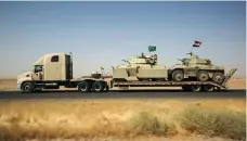  ?? AFP ?? Hashed Al Shaabi forces withdraw armoured vehicles from Tal Afar yesterday after Haider Al Abadi’s announceme­nt