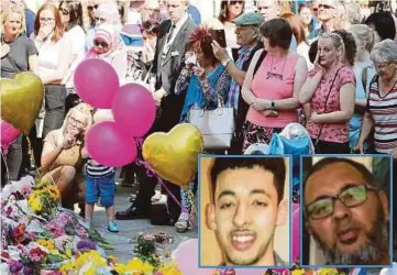  ??  ?? ORANG ramai memberi penghormat­an kepada mangsa pengeboman Manchester di Dataran St Ann, Manchester, Britain, semalam. Gambar kecil, Salman (kiri) dan bapanya, Ramadan (kanan). - Agensi