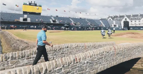  ??  ?? Tyrrell Hatton walks over the bridge onto the 18th green at Carnoustie ahead of today’s start of The Open.