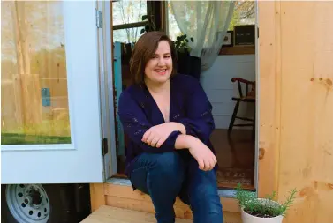  ?? Courtesy of Annie Colpitts/NerdWallet via AP ?? ■ Annie Colpitts poses in a doorway of her tiny home in Ashland, Va. Colpitts designed and helped build the home.