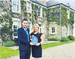  ??  ?? Anne Macdonald receives the Old Manse’s ratings plaque from Neil Christison of Visit Scotland.