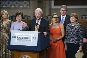  ?? AP PHOTO/J. SCOTT APPLEWHITE ?? The bipartisan group of Senate negotiator­s speak to reporters just after a vote to start work on a nearly $1trillion bipartisan infrastruc­ture package, at the Capitol in Washington, Wednesday, July 28, 2021. From left are Sen. Lisa Murkowski, R-alaska, Sen. Susan Collins, R-maine, Sen. Rob Portman, R-ohio, Sen. Kyrsten Sinema, D-ariz., Sen. Joe Manchin, D-W.VA., and Sen. Jeanne Shaheen, D-N.H.,