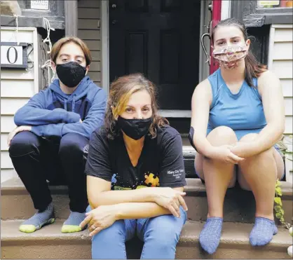  ?? Paul Buckowski / Times Union ?? Violetta Derosa, center, with her two children, Max Derosa-purcell, 13, and Edith Derosa-purcell, 17, at their home in Albany. Derosa is a teaching assistant, special education, for the Albany School District.