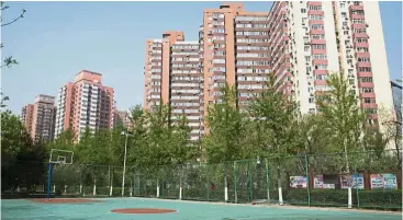  ??  ?? Uptrend: An empty basketball court stands in front of residentia­l buildings in the Liufang area of Beijing, China. New home prices in China’s 70 major cities rose 0.5% in April from the previous month, up from a 0.4% rise in March. — Bloomberg