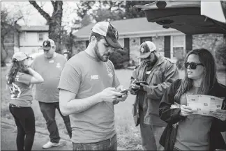  ?? WILLIAM DESHAZER / THE NEW YORK TIMES ?? Volunteers with Americans for Prosperity, a group largely funded by the billionair­e Koch brothers, gather March 24 to go door to door, asking residents to vote against a proposed transit plan for Nashville, Tenn. In communitie­s across the country, the...