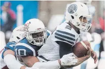  ?? GRAHAM HUGHES
THE CANADIAN PRESS FILE PHOTO ?? Toronto Argonauts quarterbac­k James Franklin, right, is tackled by Alouettes linebacker Hénoc Muamba (10) and defensive end John Bowman in Montreal on Oct. 28, 2018.