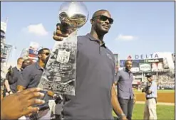  ??  ?? Plaxico Burress shows off Super Bowl XLII Lombardi Trophy Saturday in Bronx as Yanks honor 10th anniversar­y of Giant champs.