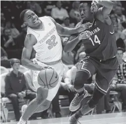  ?? THE ASSOCIATED PRESS ?? Tennessee guard Chris Darrington, left, is fouled by South Carolina forward Ibrahim Famouke Doumbia during Tuesday’s game at Thompson-Boling Arena.