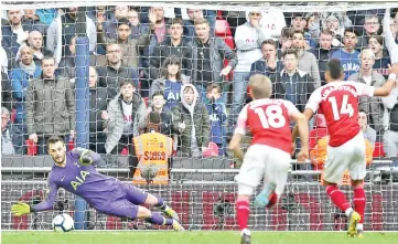  ??  ?? Tottenham Hotspur’s French goalkeeper Hugo Lloris (L) saves this penalty from Arsenal’s Gabonese striker Pierre-Emerick Aubameyang (R) during the English Premier League football match between Tottenham Hotspur and Arsenal at Wembley Stadium in London, on March 2, 2019. - AFP photo