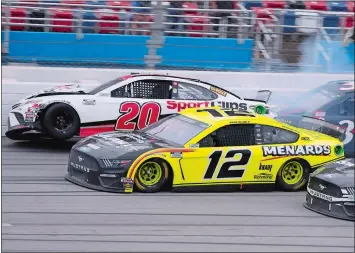  ?? JOHN BAZEMORE/AP PHOTO ?? Winner Ryan Blaney (12) approaches the finish line as driver Erik Jones (20) crashes at the finish of Monday’s NASCAR Cup Series race at Talladega Superspeed­way in Talladega Ala.