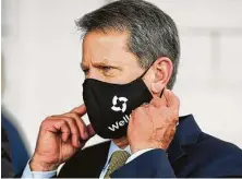  ?? Mike Stewart / Associated Press ?? Georgia Gov. Brian Kemp has filed a lawsuit challengin­g the authority of Atlanta leaders to require masks inside city limits.
