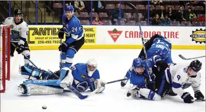  ?? DAVID CROMPTON/The Okanagan Sunday ?? Penticton Vees goalie Mat Robson swats the puck away from a wild scramble in front of the net Saturday at the SOEC. Robson got the shutout as the Vees blanked the Wenatchee Wild 2-0.