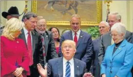  ?? AP ?? Donald Trump signs bills in the Roosevelt Room of the White House in Washington on Monday.