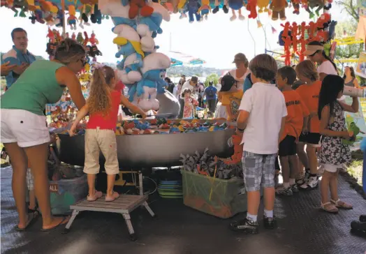  ?? Audrey Whitmeyer-Weathers / The Chronicle 2011 ?? Kids crowded around a fishing game in the hopes of winning a prize at the Marin County Fair in San Rafael in 2011.