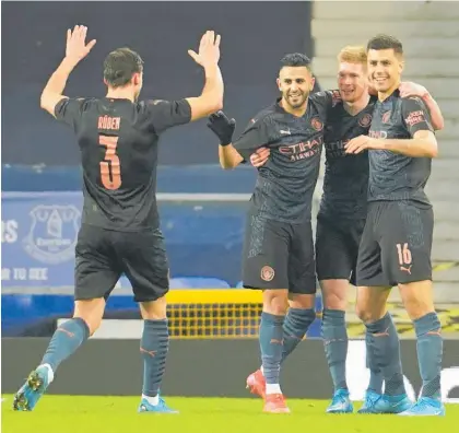  ?? Photos / AP ?? Manchester City's Kevin De Bruyne (second right) celebrates after scoring his side's second goal against Everton.