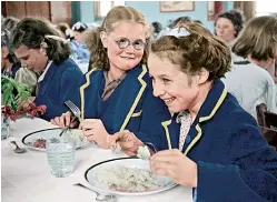  ??  ?? WE’LL EAT AGAIN Schoolgirl­s from Wakefield, West Yorkshire, in their smart blazers enjoy a meal on a summer trip to the seaside near Hull in August 1948