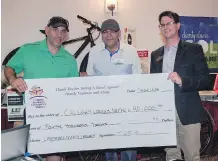  ?? LANDMARK HOMES ?? Constructi­on manager for Landmark Homes Reno Volpi, left, and Landmark’s GM Sam Attia present a cheque for $40,000 to Paul Chambers of the Calgary Women’s Emergency Shelter. The donation will pay for one outreach worker or one crisis counsellor for a...