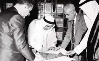  ?? —KUNA ?? KUWAIT: Sheikh Abdullah Al-Salem Al-Sabah signs a document to end the British Protectora­te Treaty, replacing it with a friendship agreement between the government­s of Kuwait and Britain.