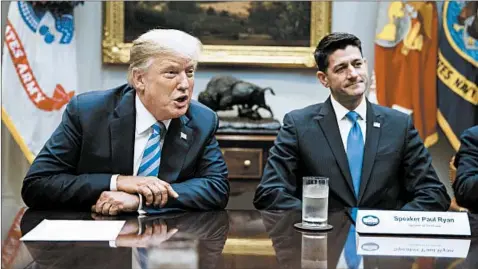  ?? EVAN VUCCI/AP ?? House Speaker Paul Ryan, R-Wis., showed the president glossy photos of a wall being built along the U.S.-Mexico border.