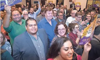  ??  ?? Supporters cheer Kyrsten Sinema shortly after the AP confirmed her Senate victory.