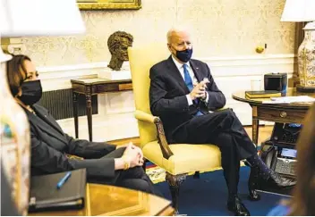  ?? SAMUEL CORUM GETTY IMAGES ?? President Joe Biden holds a meeting with Vice President Kamala Harris and other lawmakers in the Oval Office on Wednesday. Biden agreed to scale back eligibilit­y for stimulus payments.