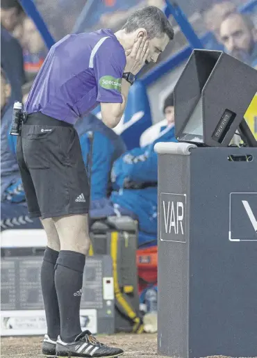  ?? ?? ↑ The referee checks his pitch-side VAR monitor during a match at Mcdiarmid Park