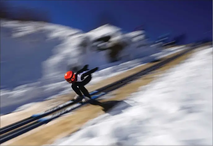  ?? ROBERT F. BUKATY — THE ASSOCIATED PRESS ?? Islay Sheil, 14, of Lakeville, Conn., speeds down a 39-meter jump during the Eastern Ski Jumping Meet, Sunday, Jan. 21, 2024, in Milan, N.H.