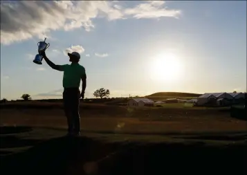  ?? ASSOCIATED PRESS PHOTOS ?? BROOKS KOEPKA POSES WITH THE WINNING TROPHY after the U.S. Open on Sunday at Erin Hills in Erin, Wis.