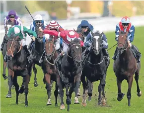  ??  ?? Andrea Atzeni drives the William Haggas-trained Rivet on as the Italian jockey landed a fourth straight success in the Racing Post Trophy at Doncaster on Saturday.