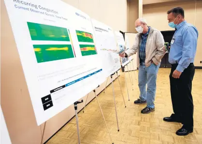  ?? KYLE TELECHAN/POST-TRIBUNE ?? Hammond resident Dave Holeman, left, speaks with Parsons Corp. Vice President Joseph Brahm during a public meeting Tuesday to gather input for a traffic study of the Borman Expressway at Purdue University Northwest in Hammond.