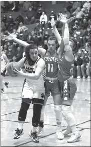  ?? Becky Finney ?? Emily Martindale of Sandhills-Thedford drives to the hoop as Hadlee Safranek and Kirsten Myers of Anselmo-Merna trap her. The Coyotes finished the game with 54 rebounds compared to 33 rebounds for the Knights.