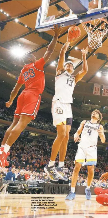  ?? GETTY ?? Marquette’s Oso Ighodaro goes up for shot as David Jones of St. John’s defends in second half of quarterfin­al game Thursday at Garden.