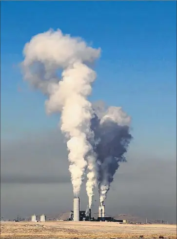  ?? Josh Stephenson Durango Herald ?? A HAZE LOOMS west of the Four Corners Generating Station in New Mexico. Arizona Public Service says it will transition to 100% carbon-free electricit­y by 2050 and close the coal units at Four Corners by 2031.