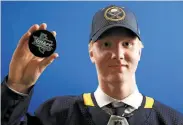  ?? Tom Pennington / Getty Images ?? As expected, defenseman Rasmus Dahlin was taken by Buffalo with the first pick in the NHL draft.