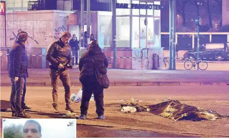  ??  ?? Italian police and forensics experts stand by the body of suspected Berlin truck attacker Anis Amri after he was shot dead in Milan early yesterday. (Inset) An image grab taken from an Islamic State propaganda video shows Amri pledging allegiance to IS...