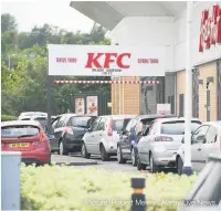  ?? Picture: Robert Melen / Alamy Live News ?? Cars queue at a KFC in Morfa, Swansea, and the litter a week later around the area.