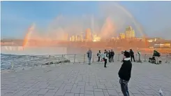  ?? | Reuters ?? A RAINBOW forms over Niagara Falls as people wait for a solar eclipse at Niagara Falls in New York, yesterday.
