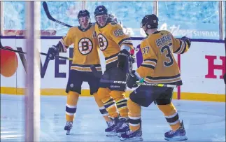  ?? Rich Pedroncell­i The Associated Press ?? Brad Marchand, left, and Patrice Bergeron celebrate the first of David Pastrnak’s three goals.