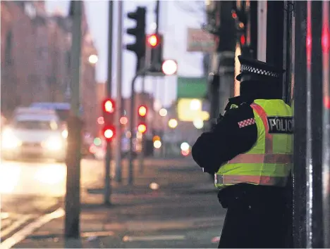 ??  ?? An officer stands guard on Albert Street today after John Watt, 50, was allegedly murdered.