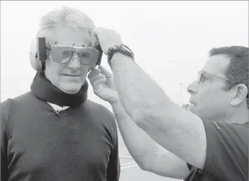  ?? Myung J. Chun Los Angeles Times ?? MIKE SPECK, right, an instructor with Ford’s Driving Skills for Life program, adjusts the drunk-driving goggles on reporter Charles Fleming during a demonstrat­ion of the dangers of drunk or drugged driving.