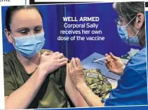  ??  ?? WELL ARMED Corporal Sally receives her own dose of the vaccine